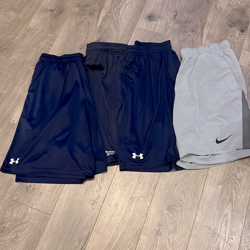 4 pairs of athletic shorts UA, Nike and Reebok